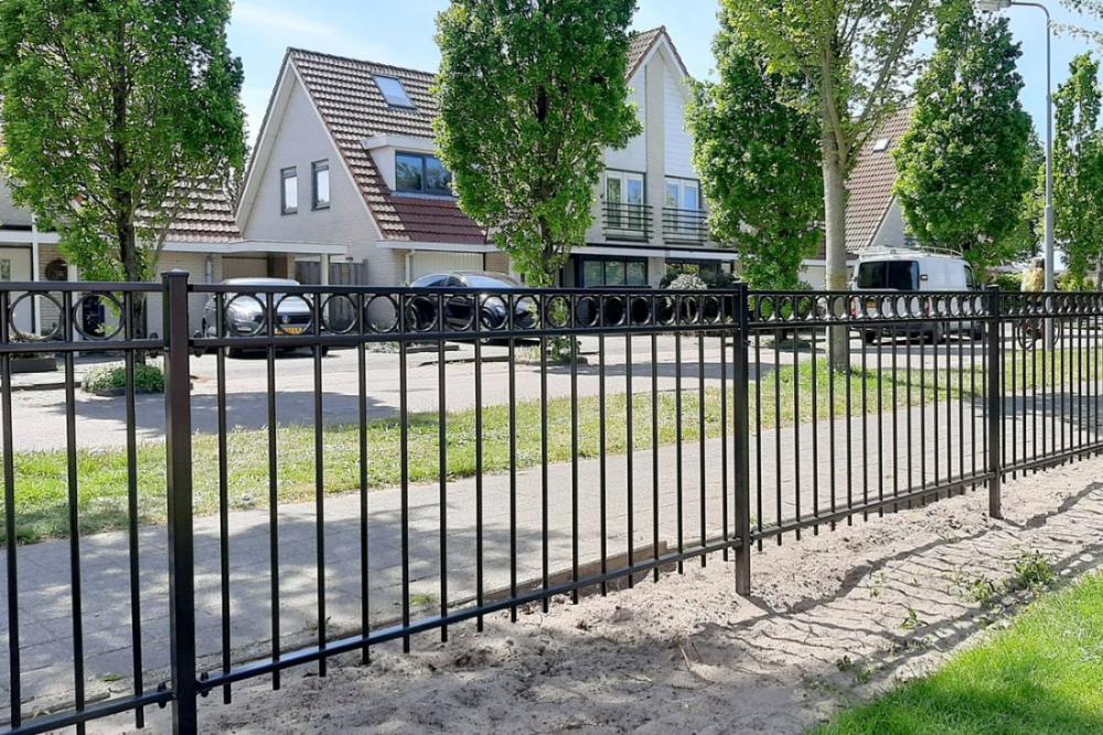 Laag sierhekje langs een border in de voortuin